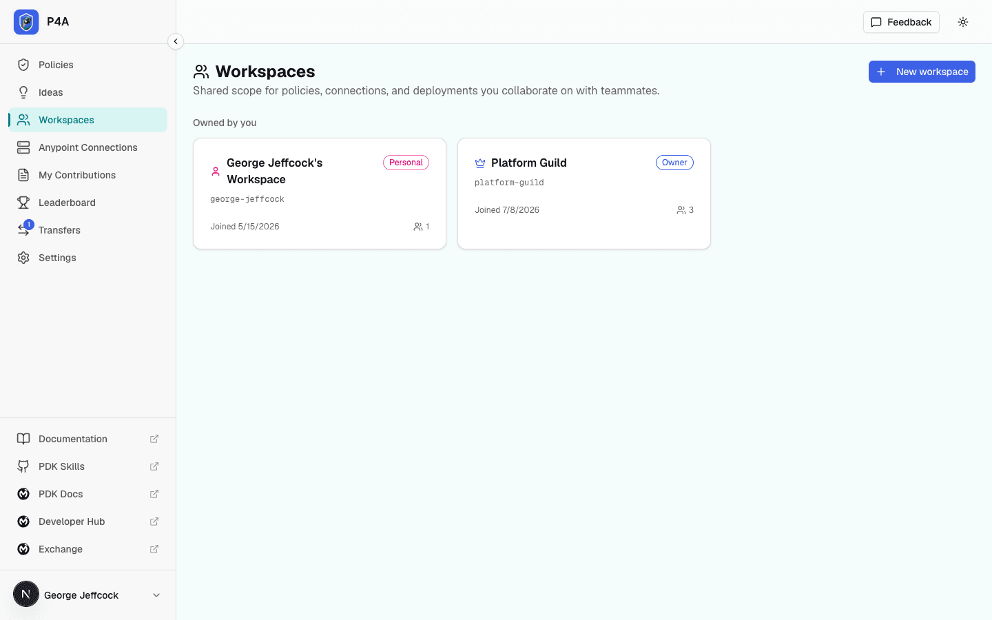 Workspaces page listing the signed-in user's personal workspace and the shared workspaces they belong to, each with a role badge